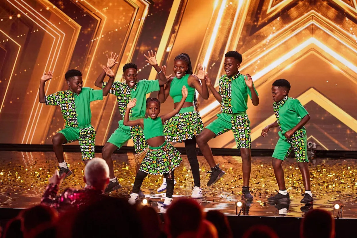 Ugandan children performing traditional dance in colorful costumes