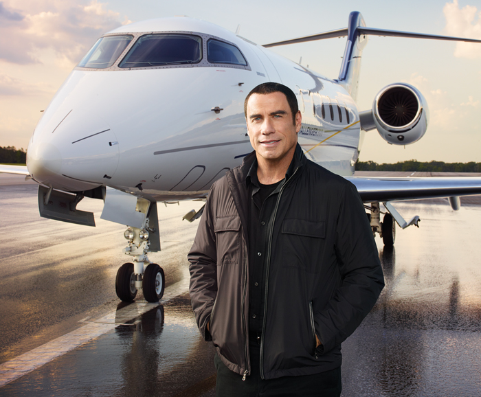 John Travolta with his private aircraft, showcasing his aviation passion