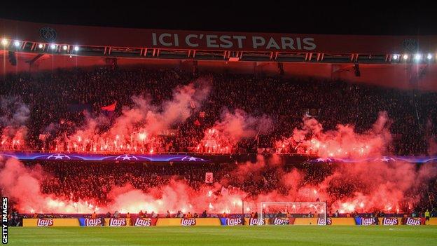 Champions League stadium atmosphere with fans celebrating