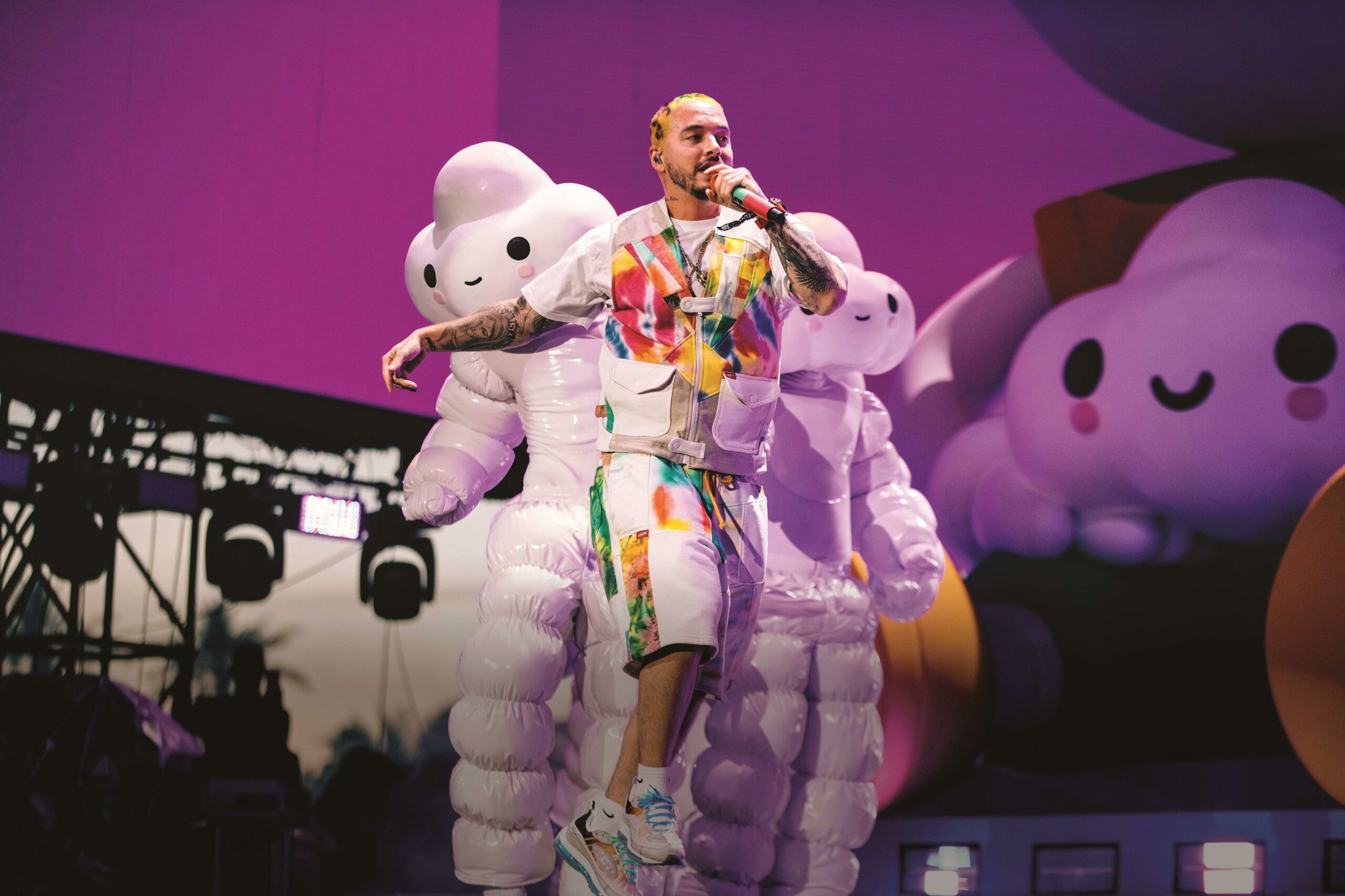 J Balvin in colorful outfit performing live