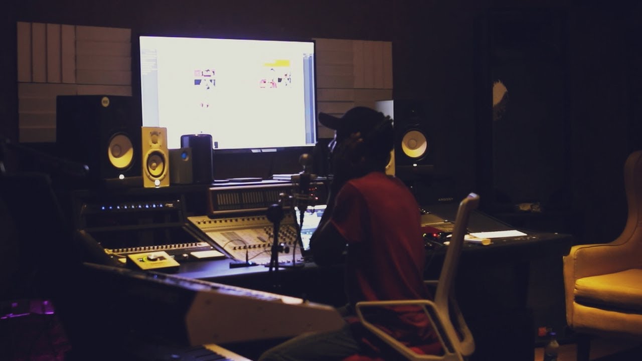 Johnny Drille in the recording studio working on music