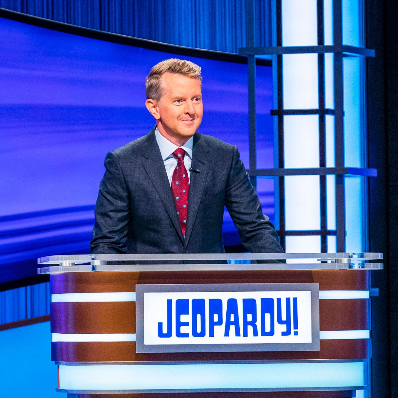 Ken Jennings in his role as Jeopardy! host at the podium