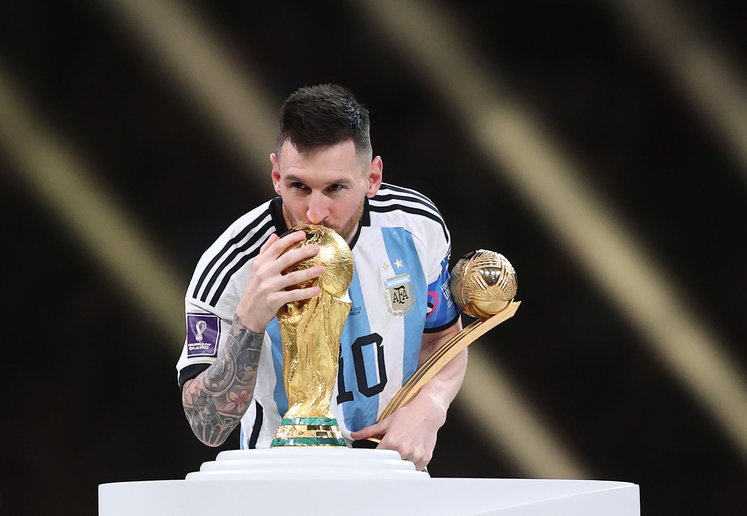 Messi holding the FIFA World Cup trophy in Qatar