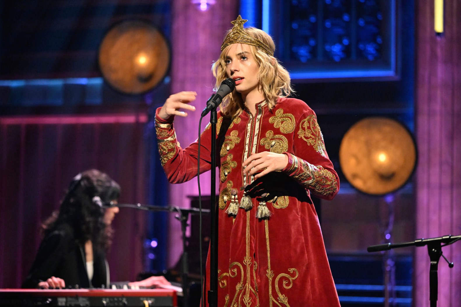 Maya Hawke performing with guitar on stage