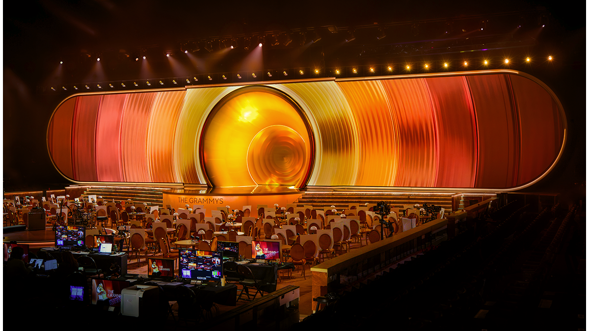 Grammy Awards ceremony with golden gramophone trophies and stage lighting