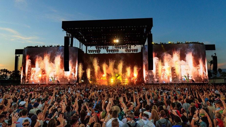 Coachella music festival main stage with crowd and desert landscape