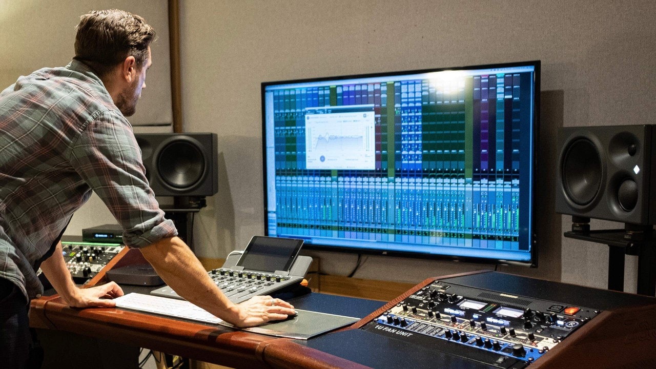 Music supervisor working in professional recording studio