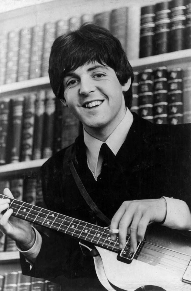 Paul McCartney performing with bass guitar