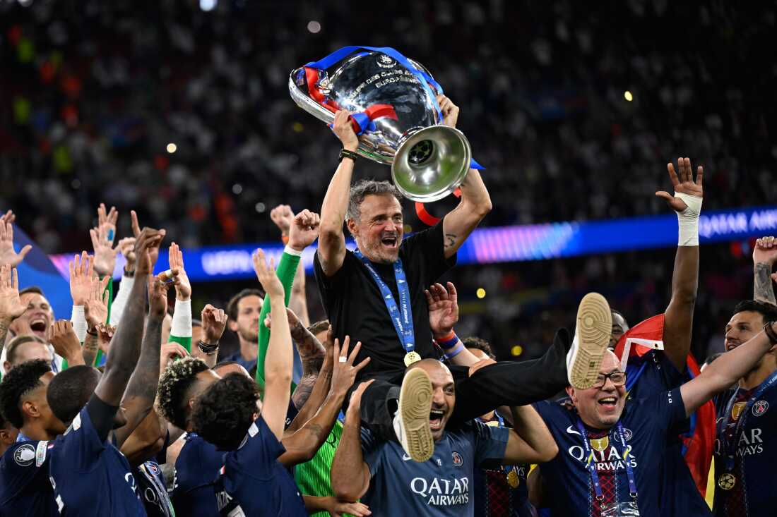 PSG players celebrating with Champions League trophy