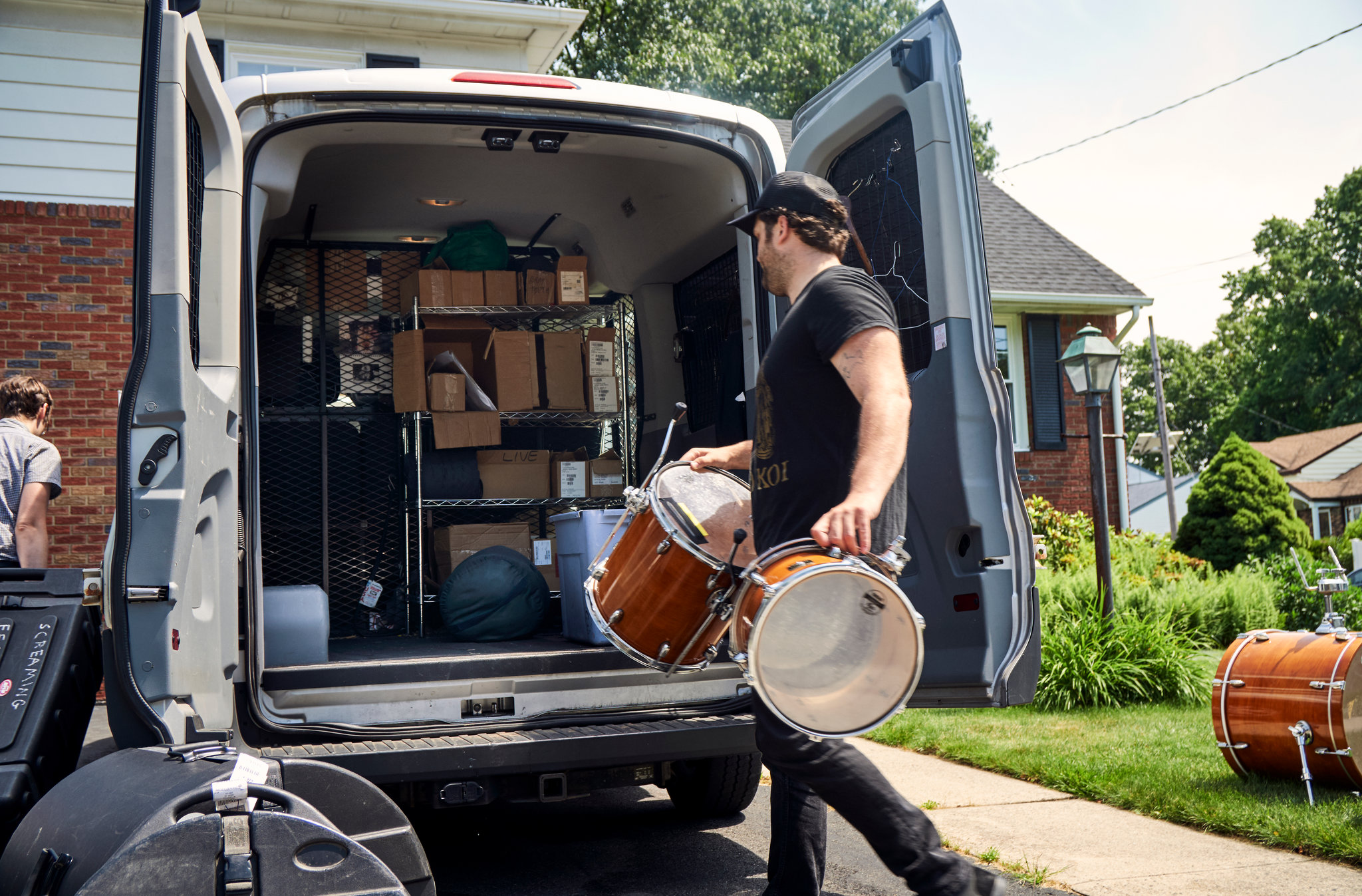 Independent musicians loading equipment into tour van