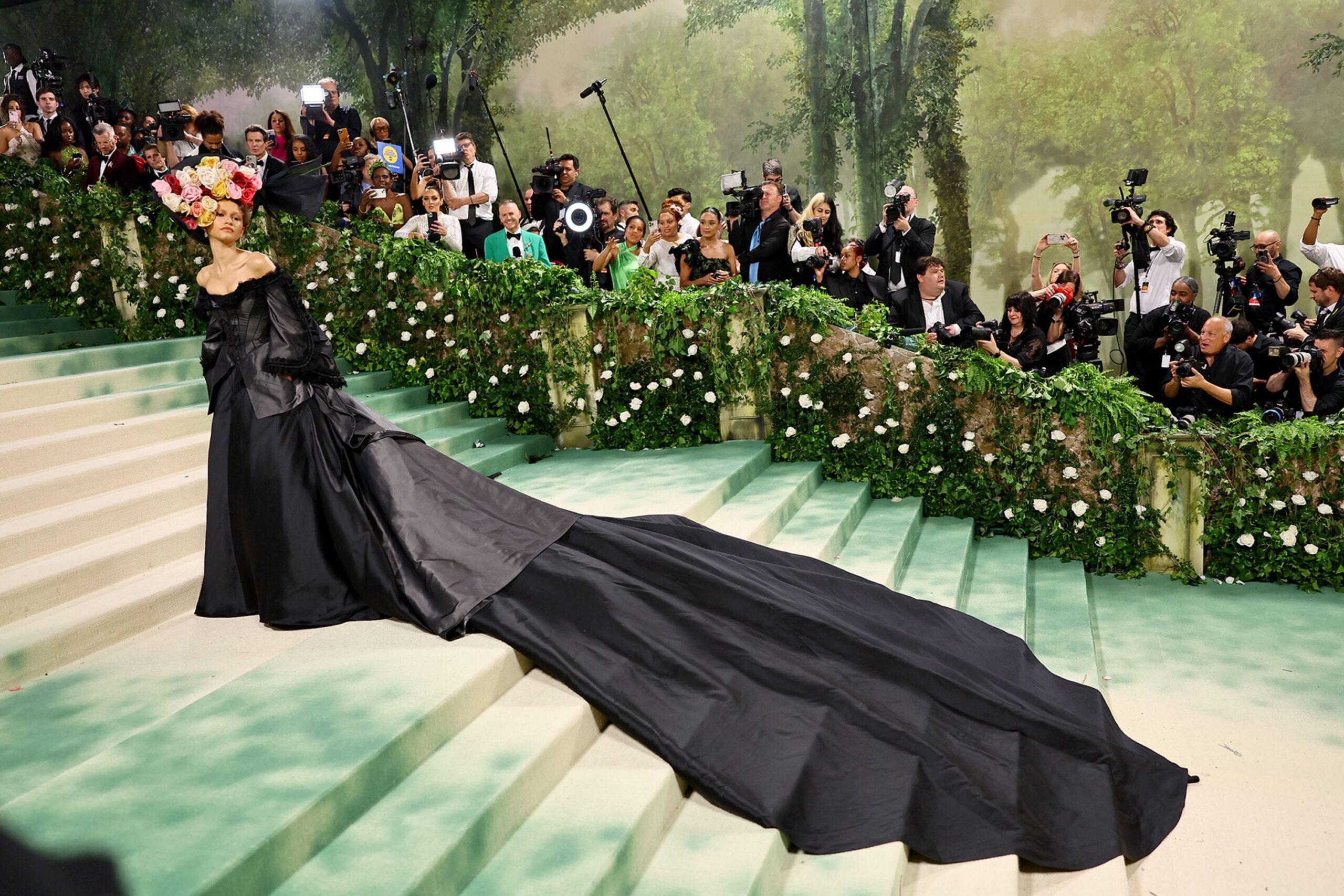 Celebrities walking the Met Gala red carpet in elaborate fashion