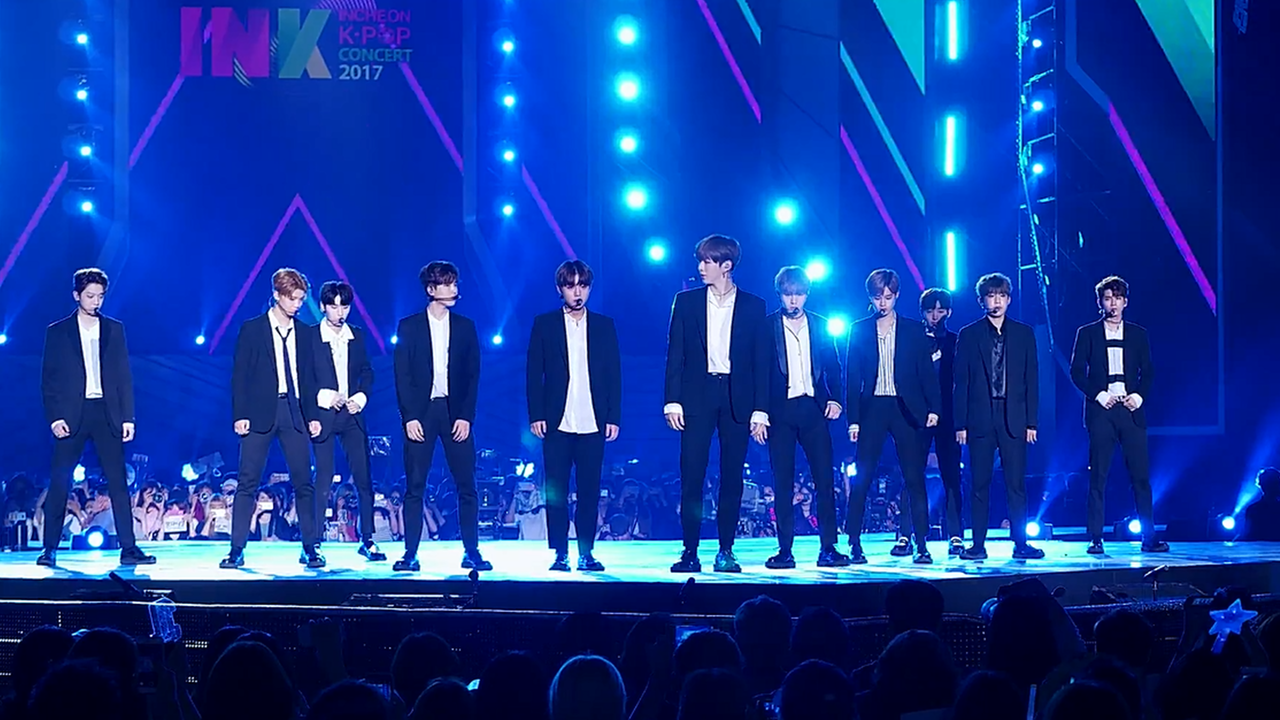 K-pop competition show performance stage with dramatic lighting