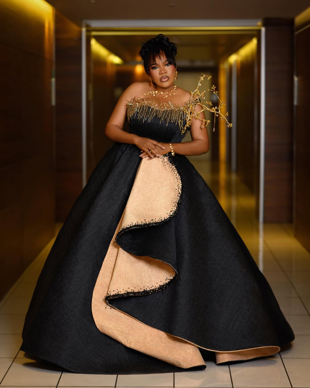 Toyin Abraham in black and champagne-gold ballgown at AMVCA ceremony