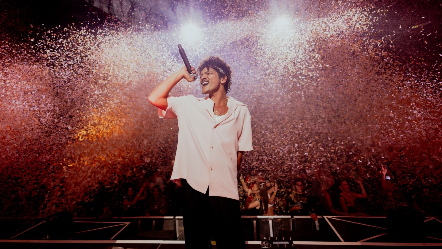 Bruno Mars performing live on stage at a major concert