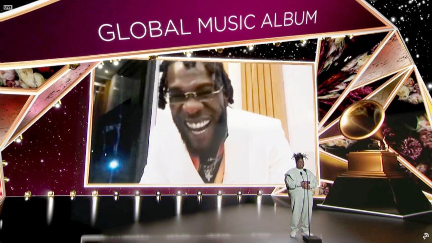 Burna Boy holding Grammy award international success