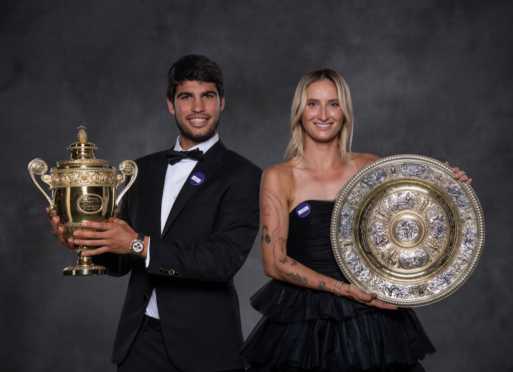 Carlos Alcaraz lifting the Wimbledon trophy