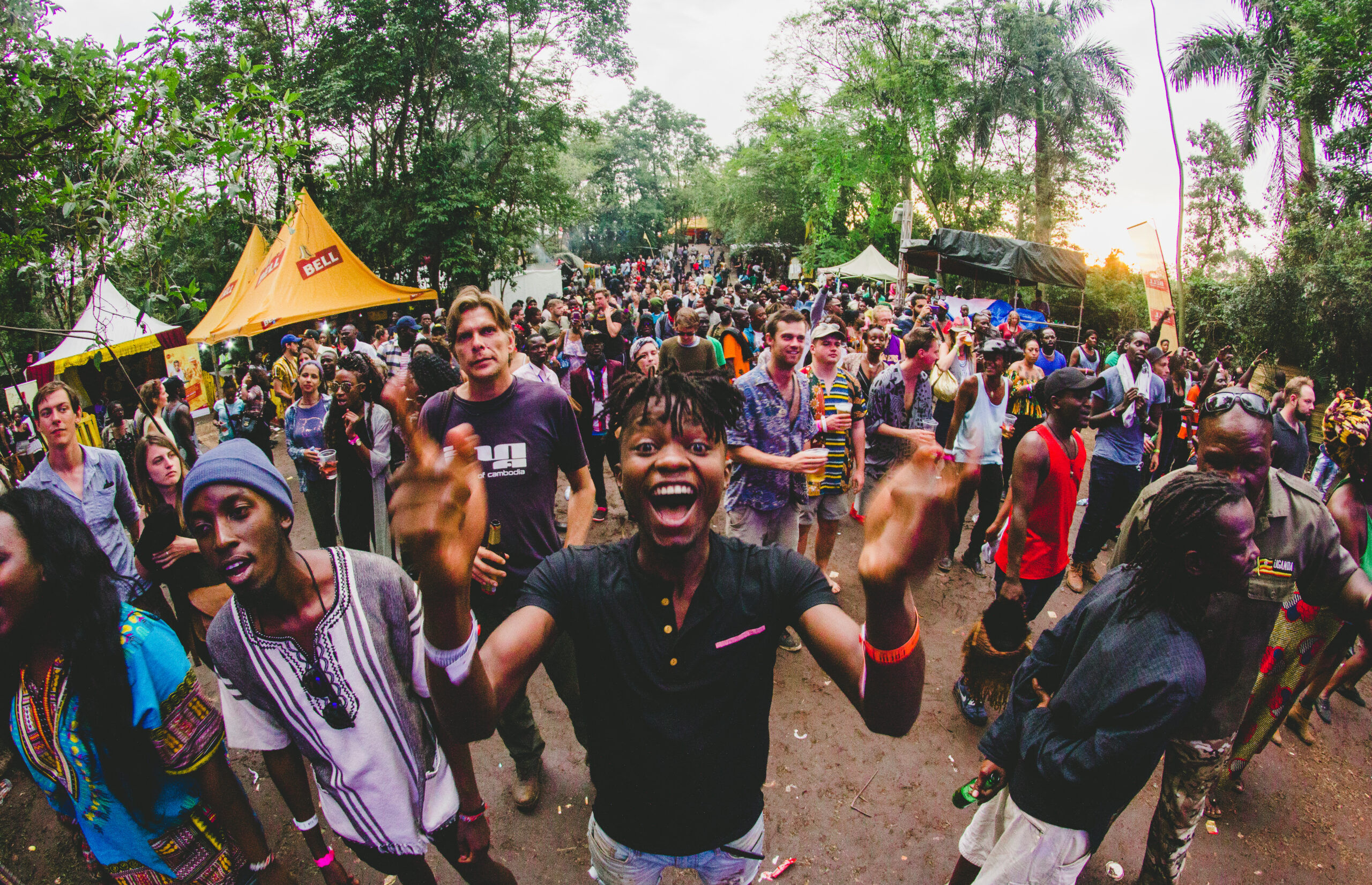 Large crowd at African music festival with performers on stage