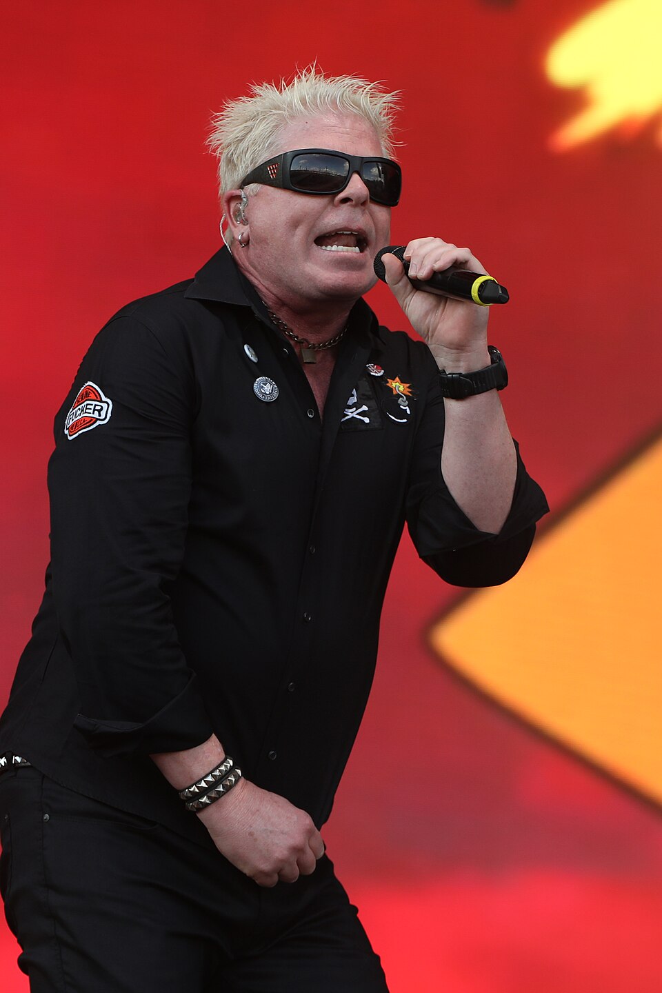 Dexter Holland singing into microphone during The Offspring performance