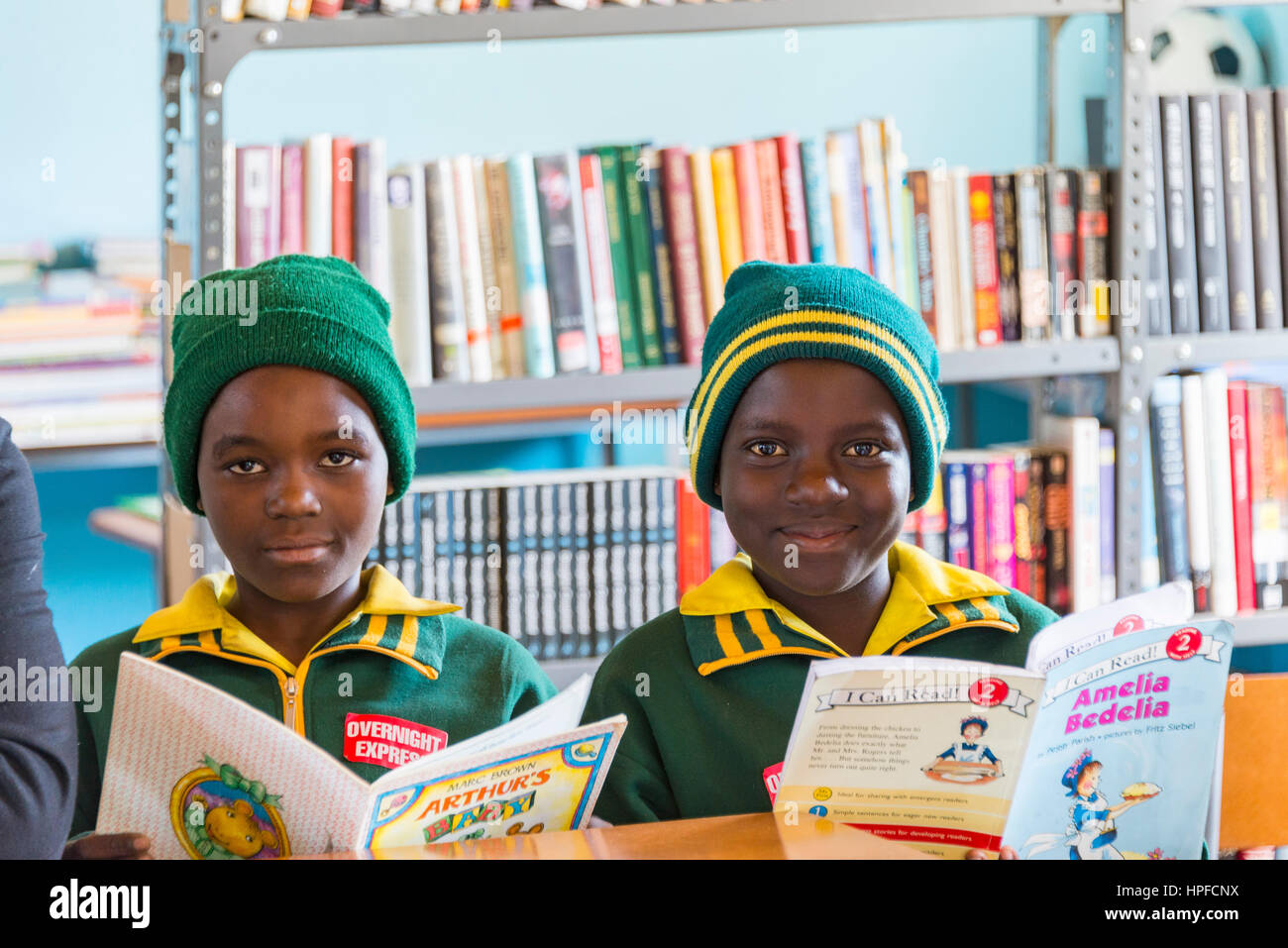 African children engaged in reading activities in classroom setting