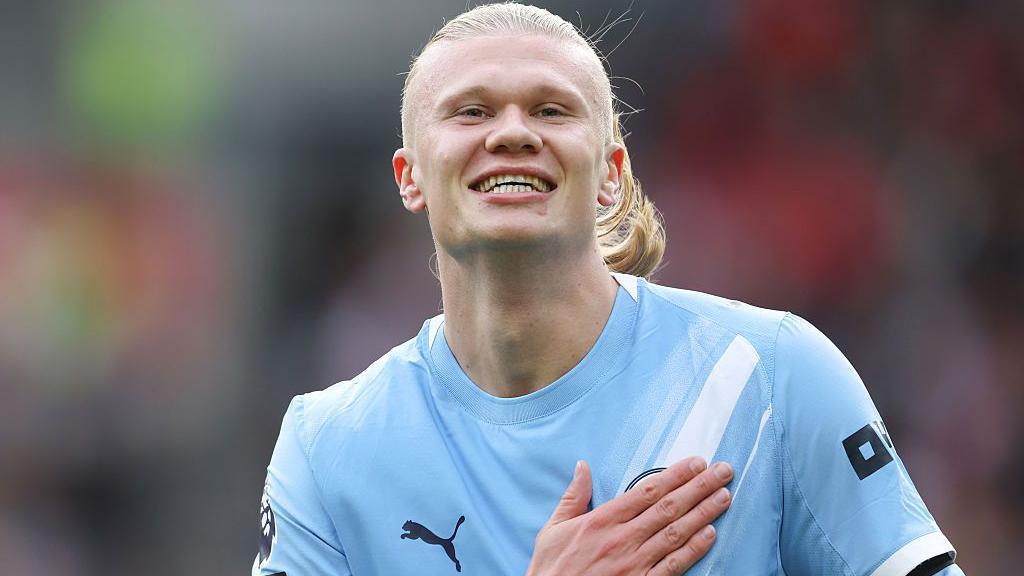 Erling Haaland in Manchester City uniform celebrating a goal