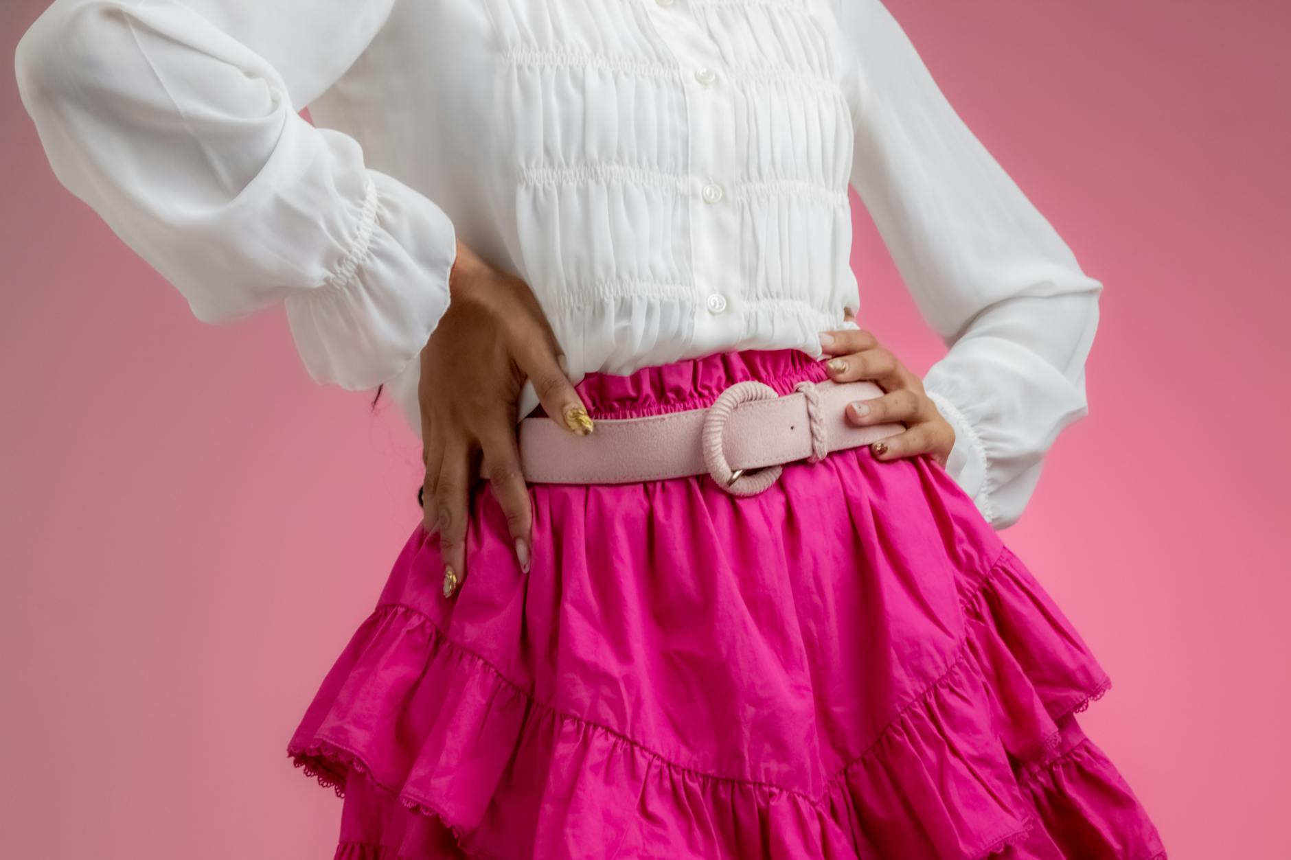Hilda Baci in pink aso-oke mini skirt and buba