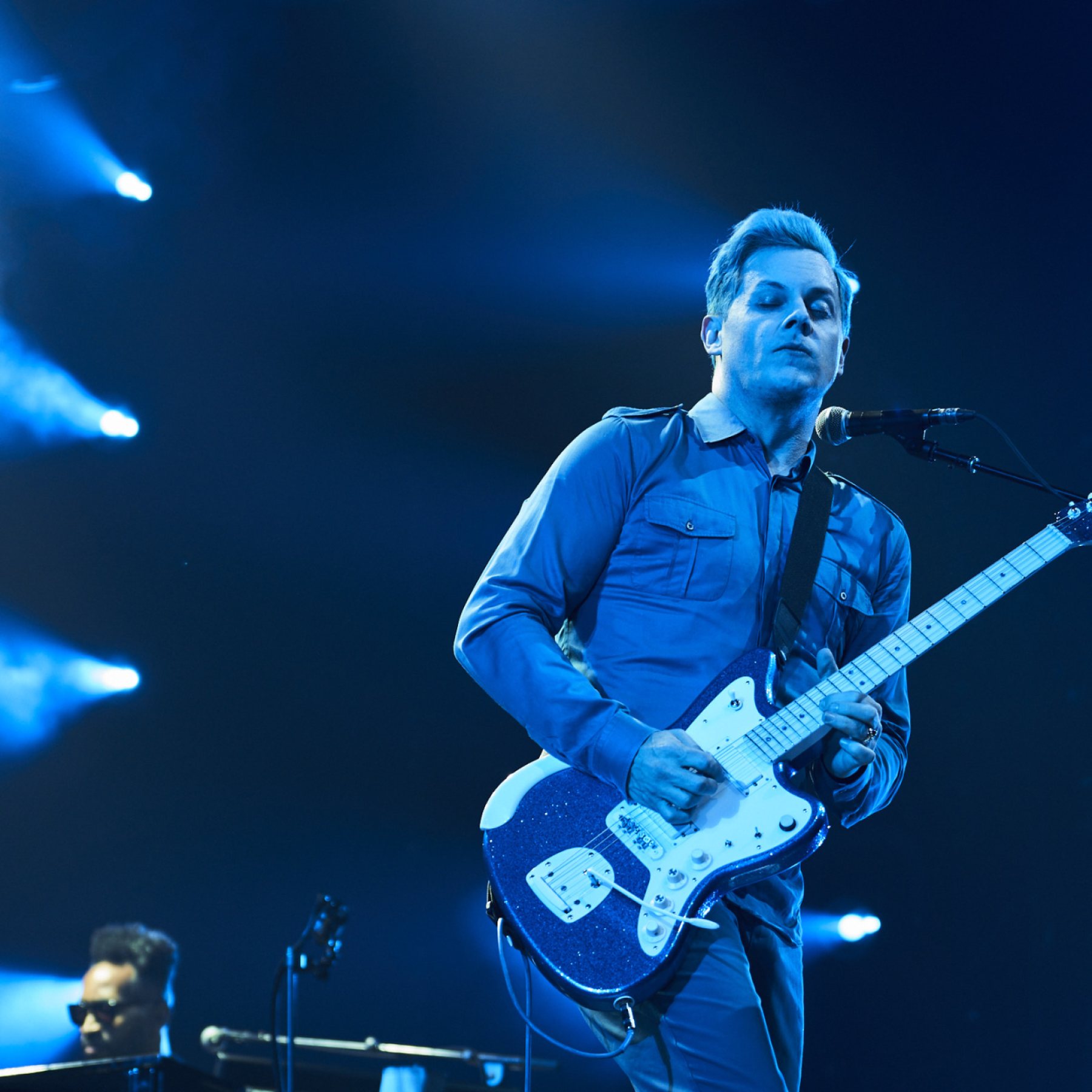 Jack White performing live on stage with guitar