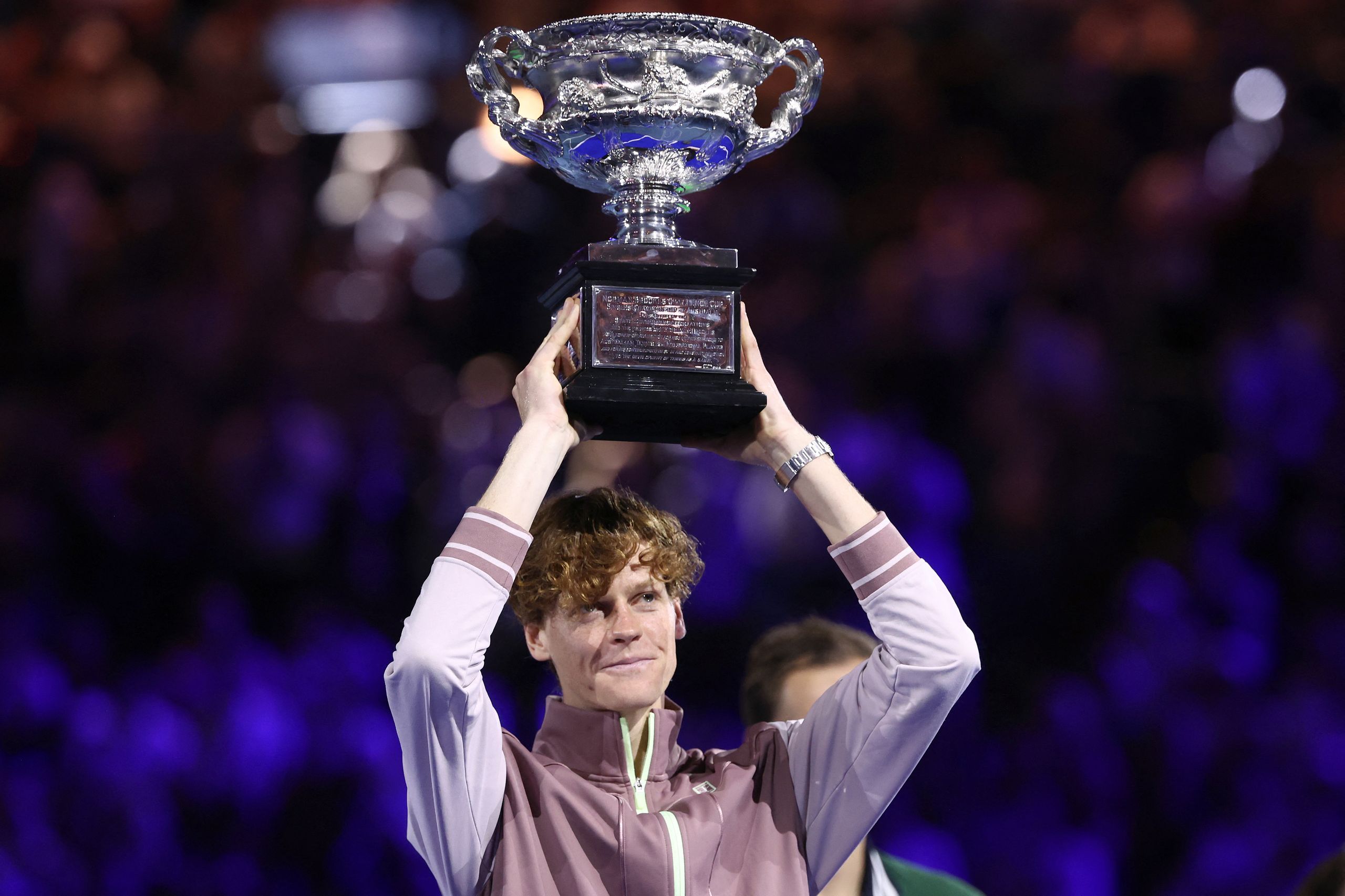 Jannik Sinner lifting the Australian Open trophy in 2024