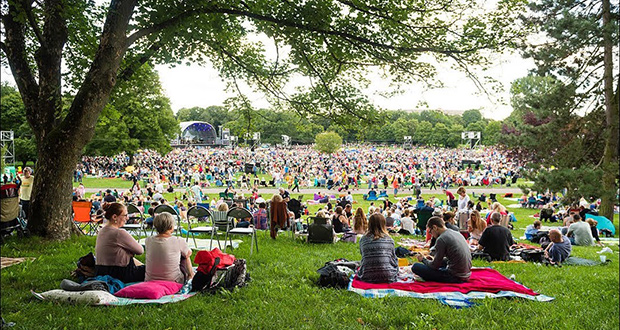 Large outdoor music festival crowd stage performance Europe