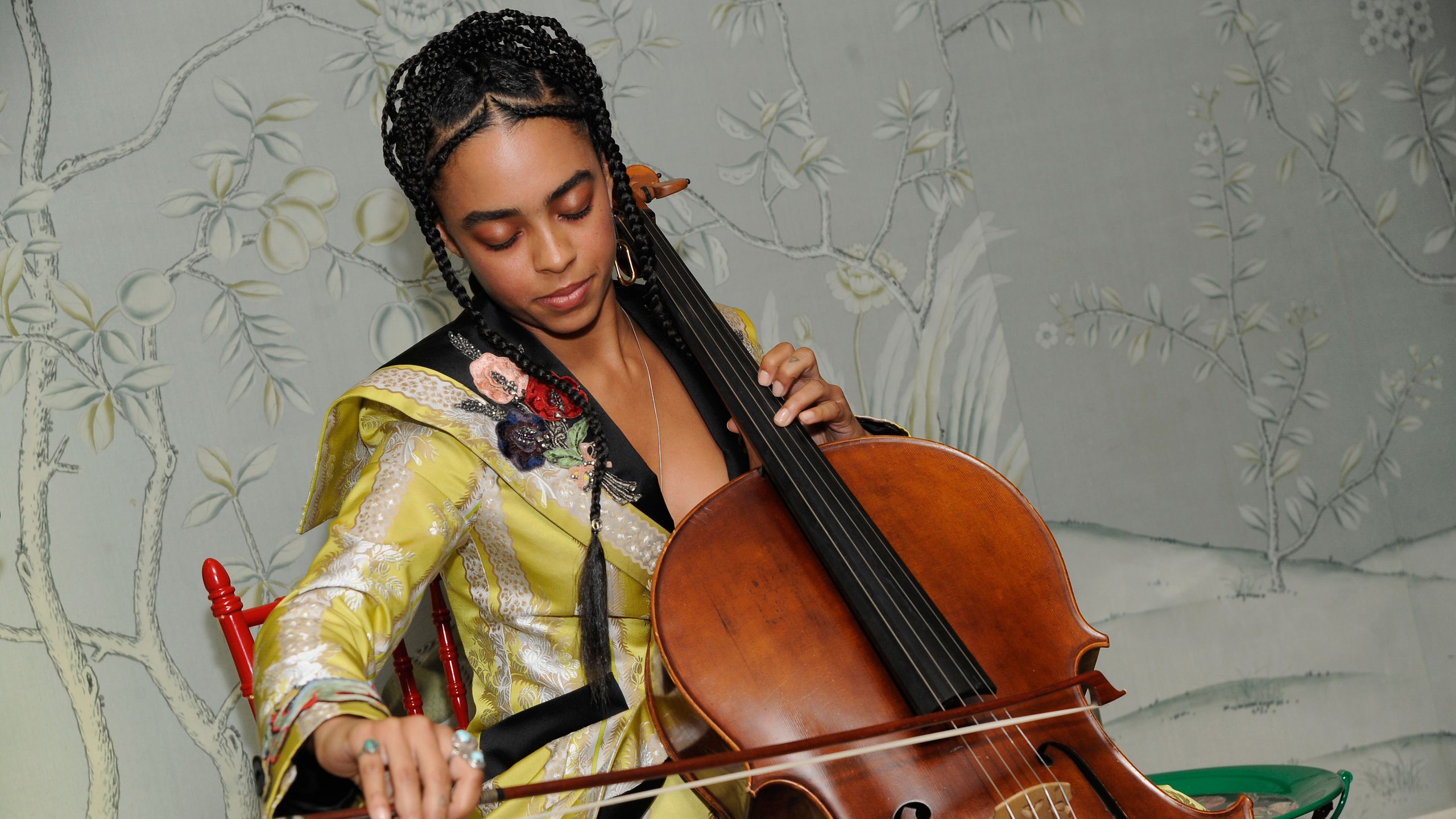 Kelsey Lu performing with her cello on stage