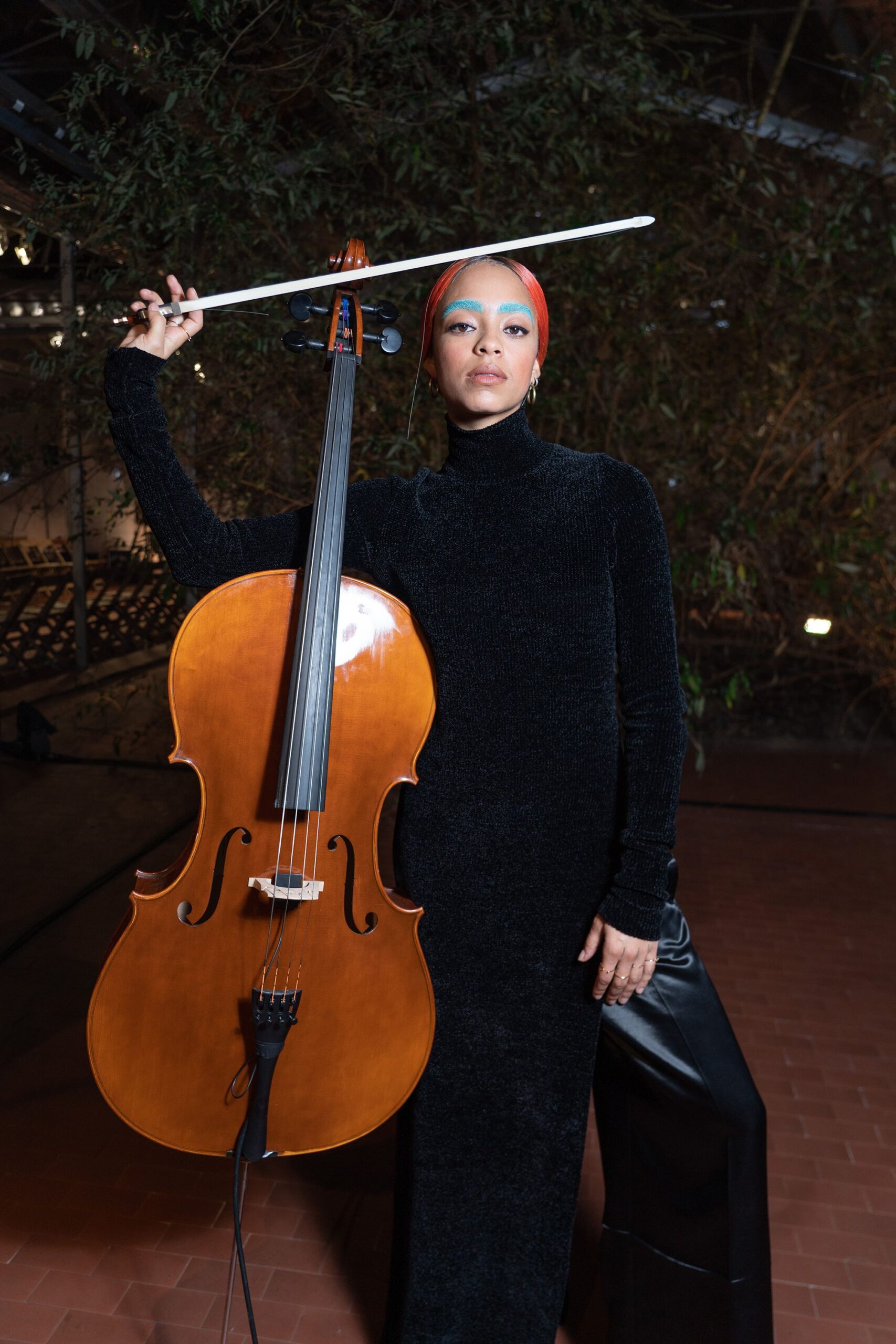 Kelsey Lu with cello in artistic performance setting