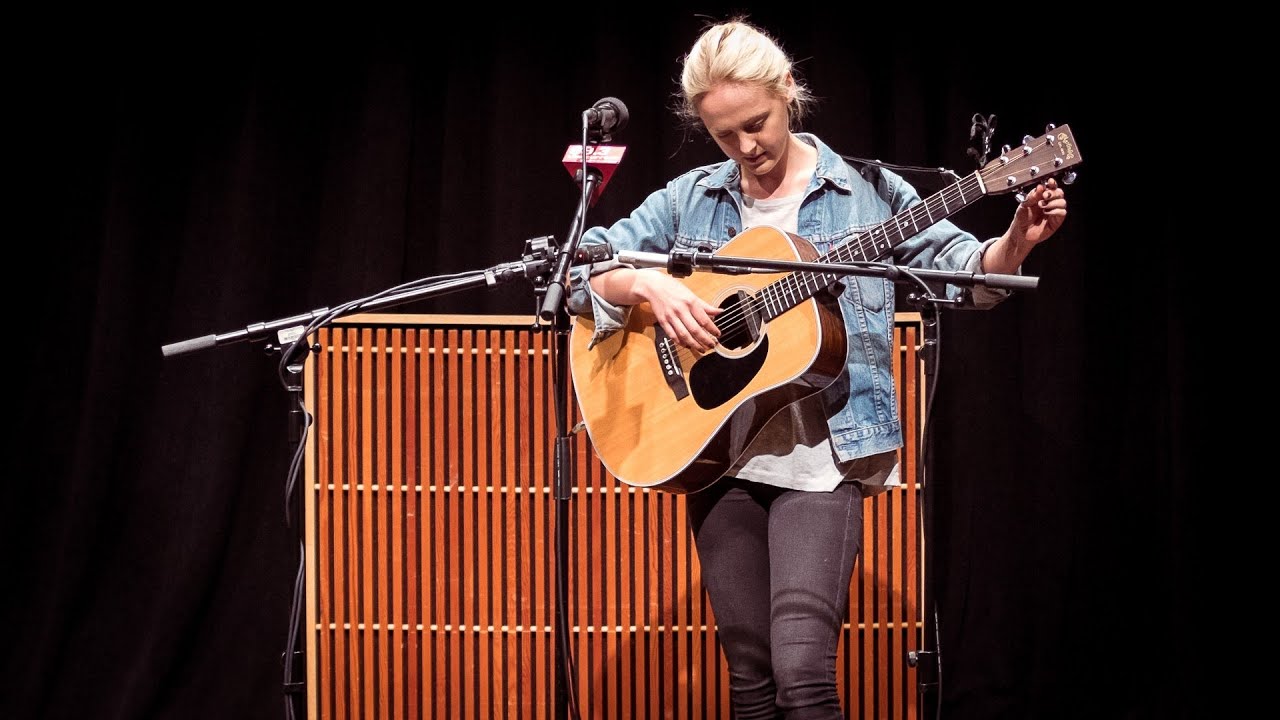 Laura Marling performing with acoustic guitar on stage