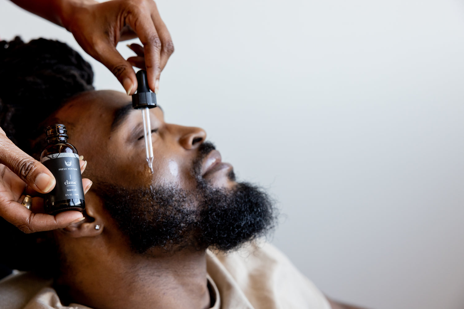 A Nigerian man maintaining his beard and skincare grooming routine