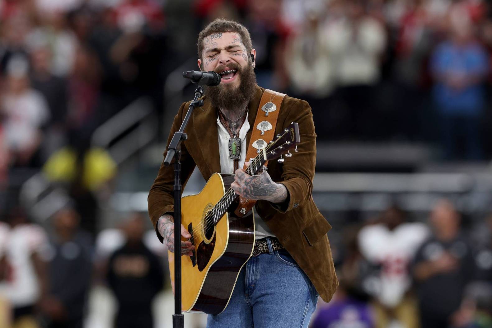 Post Malone performing on stage during his 2025 concert tour