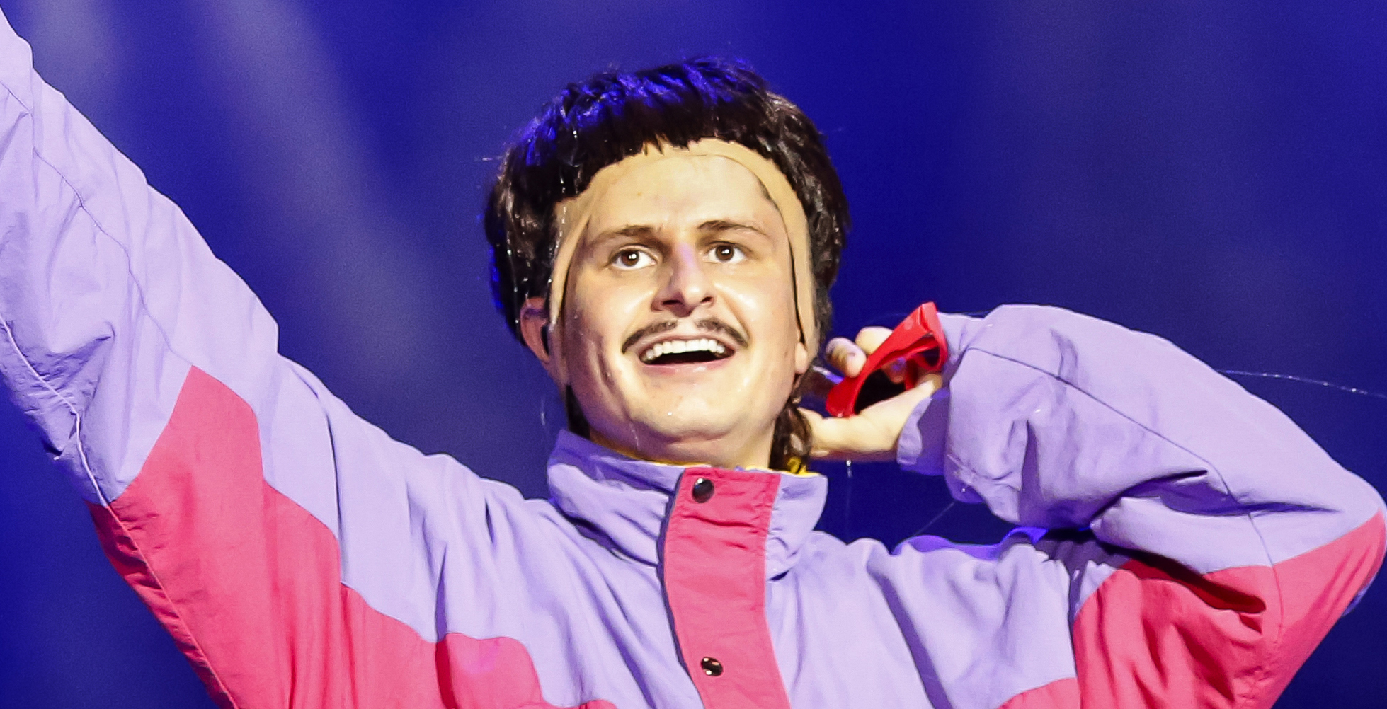 Oliver Tree performing on stage in his signature style