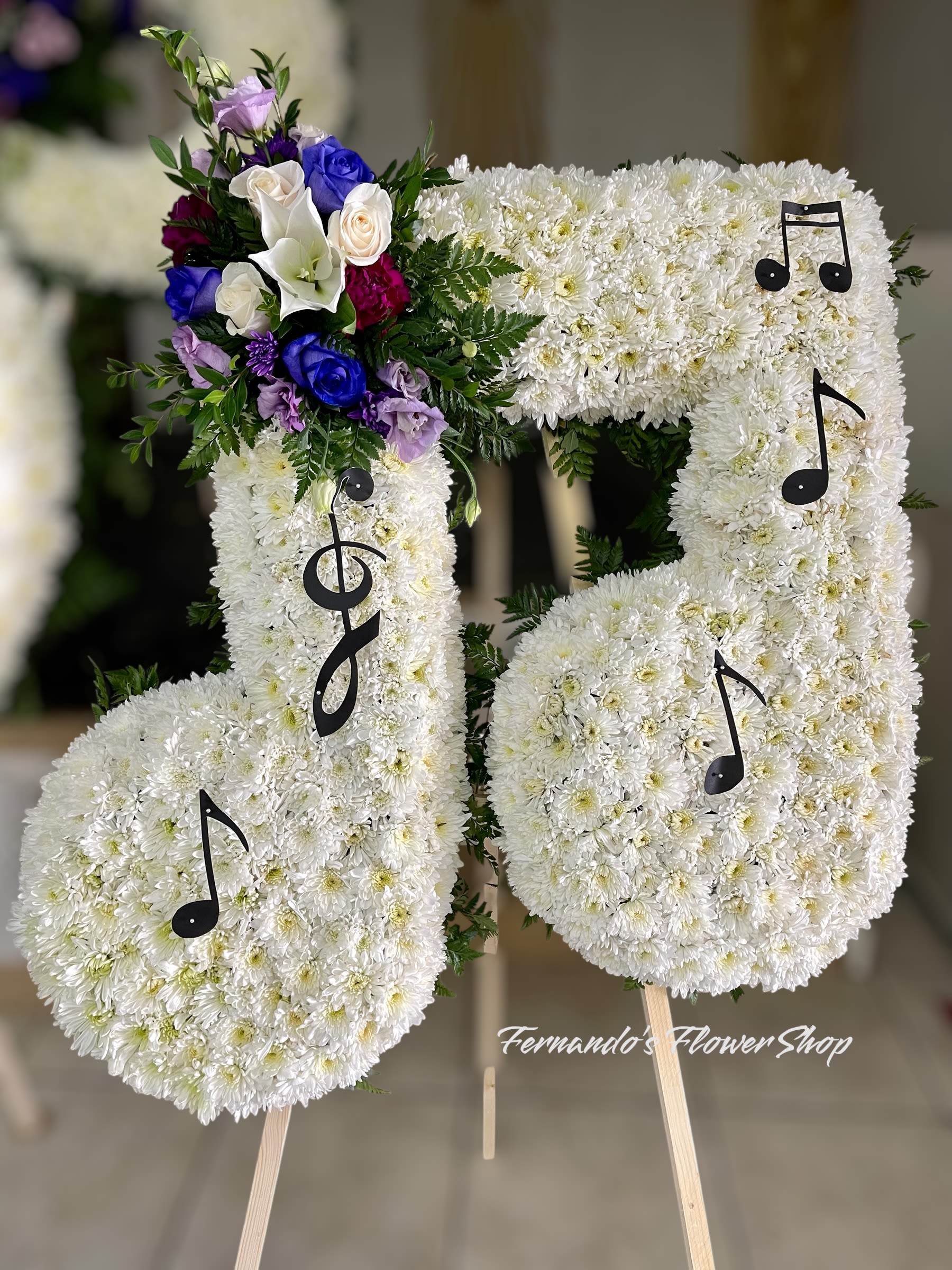 Memorial tribute with flowers and musical notes for songwriter