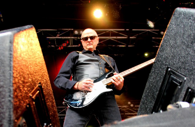 Rick Brewster playing guitar with The Angels