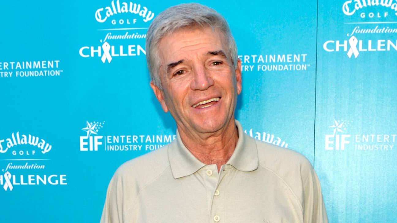 Tom Dreesen performing stand-up comedy on stage
