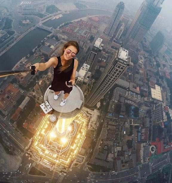 Angela Nikolau posing on a rooftop for social media photography