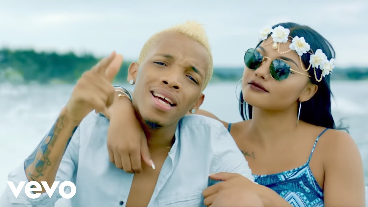 Tekno Miles in a music video scene